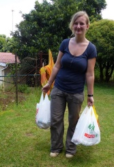 Belgian volunteer Benedicte Scheen carries a few of the 50 monthly supplementary food parcels.